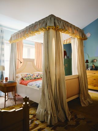 Image may contain Furniture Bed Bedroom Indoors Room Lamp Desk Table and Canopy Bed