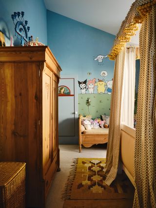 Image may contain Indoors Interior Design Home Decor Rug Furniture Bed Bedroom Room Person and Toy