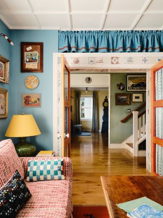 Image may contain Lamp Architecture Building Furniture Indoors Living Room Room Interior Design Couch and Art